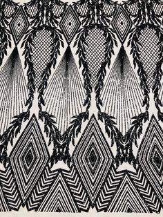 an intricate black and white pattern on fabric