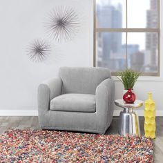 a blue chair sitting on top of a rug in a living room next to a window