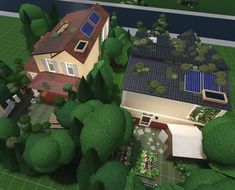 an aerial view of a house with solar panels on the roof and trees around it