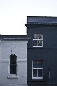 two buildings side by side, one with a clock on it