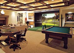 a living room filled with furniture and a pool table