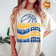 Comfort Colors Golden State Basketball Shirt, Golden State Basketball Sweatshirt, Vintage Style Golden State Basketball shirt -Please check Color and Size Charts before placing the order. You can find them in the listing's photos (Depending on what device you are viewing this listing colors may vary slightly). -Returns and exchanges are accepted only if there are defects "No Extra Costs" We create custom t-shirts with great designs for everyone's liking. If you don't find the size or color you w Golden State Outfit Women, Game Day Yellow Graphic Print Tops, Yellow School Spirit Graphic Print Top, Yellow Graphic Print Top For Game Day, Yellow Graphic Print Top For School Spirit, Yellow College Top For Team Spirit, Yellow Tops With Letter Print For Sports Events, Casual Yellow Tops For Game Day, Collegiate Yellow Tops With Letter Print