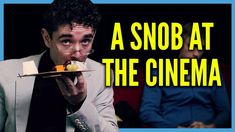 a man holding a plate with food on it in front of him and the caption reads, a snob at the cinema