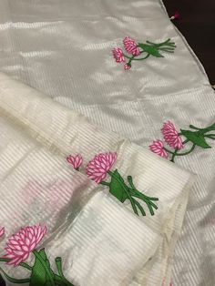 This is a beautiful handloom silk by silk maheswari silk saree in off-white in custom HAND embroidered lotus motif design. Saree is featherlight. It is extremely elegant. Saree pallu is finished with tassels. Falls and pico are done already. Blouse is unstitched and has embroidered lotus motifs. We chose lotus with leaves embroidery to complement the white body of this silk saree. Embroidery was done only in the lower half of the saree,  to maintain the simplicity of the saree, yet adding a pop of colour. Colour may vary slightly depending upon the lighting and individual device settings. Handloom products may have some irregularities unlike power loom products. All sales are final. Dry clean only. Off White Silk Saree For Festivals, Off-white Silk Saree For Festivals, White Silk Handloom Traditional Wear, White Silk Handloom Dupatta, Off White Art Silk Saree With Cutdana, Silk Saree With Zari Work In Off White, Off White Silk Saree With Zari Work, Silk Off-white Saree With Zari Work, Diwali Silk Saree In Off White