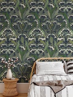 a bed sitting next to a wall with a green and white pattern on the wall