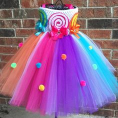 a colorful tutu skirt with lollipops on the bottom and a bow at the waist