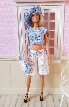 a barbie doll wearing a blue crochet top and white shorts with black shoes