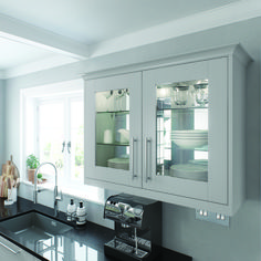 a kitchen with white cabinets and black counter tops