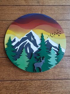 a paper cut out of a deer in the mountains