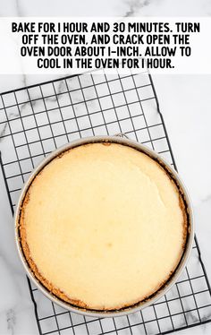 a pie sitting on top of a cooling rack next to a white marble countertop