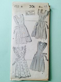 an old sewing book with four dresses on it