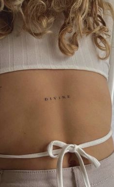 a woman's back with the word dive tattooed on her left ribcage