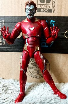 the action figure is posed in front of a cardboard box with it's hands out