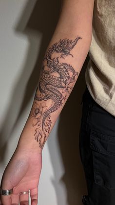 a person with a dragon tattoo on their arm