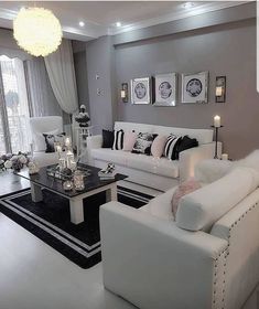 a living room filled with white furniture and decor