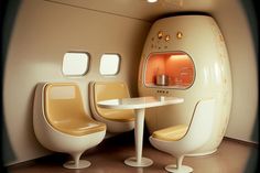 the interior of an airplane with two chairs and a table in front of it,