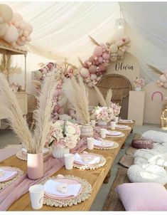 the table is set with pink and white decorations