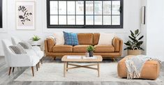 a living room with couches, chairs and rugs in front of a window