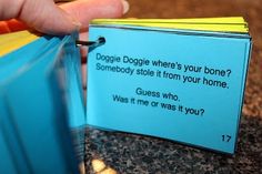 a hand holding a blue book with a note attached to it that says dogggie dogie where's your bone? somebody stole it from your home guess who was me or what?