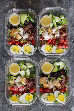 four plastic containers filled with different types of food