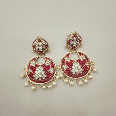 Elegant gold foil Coral & Lotus Kundan Chandbali earrings featuring pearl drops. The lotus kundans add a touch of serenity, while the coral accents bring warmth and vibrancy. Perfect for adding a traditional charm to any look. Length: 3" to 3.5" Material: 24Kt gold foil, lac Stones: Kundans, semi precious corals, semi precious pearls Fusion Style Kundan Pearl Earrings For Gift, Fusion Style Meenakari Pearl Earrings For Gifts, Traditional Kundan Chandbalis With Pearl Drop, Festive Fusion Pearl Earrings With Latkans, Handmade Red Kundan Earrings, Gold Fusion Chandbalis With Pearl Drop, Festive Chandbali Pearl Earrings With Meenakari, Fusion Style Gold Chandbalis With Pearl Drop, Fusion Style Pearl Drop Jhumkas For Gift