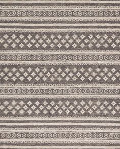 an area rug with grey and white designs on the side, in front of a black background