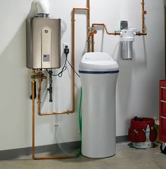 a water heater sitting next to a white tank