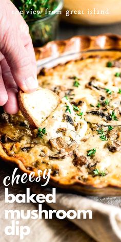 a person dipping cheese on top of a baked mushroom dip in a pie pan with parsley