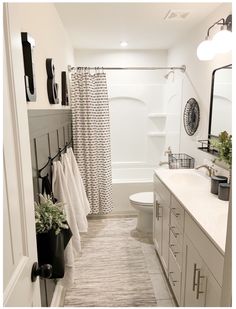 a bathroom with a toilet, sink and bathtub next to a shower curtain in it