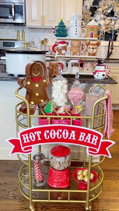 a gold metal cart with hot cocoa bar signs on it and christmas decorations in the background