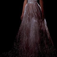 a woman in a silver dress on a black background