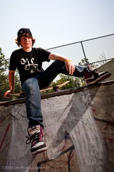 a young man riding a skateboard up the side of a ramp