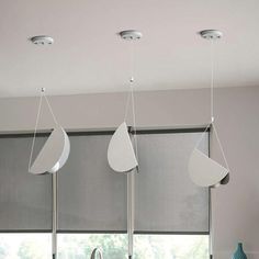 three lights hanging from the ceiling above a kitchen sink