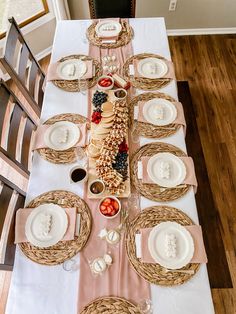 the table is set with plates, bowls and utensils for an elegant dinner