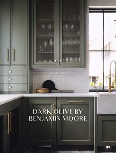 a kitchen with green cabinets and white counter tops, the words dark olive by benannn moore