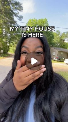 a woman holding up her face with the caption'my tiny house is here '