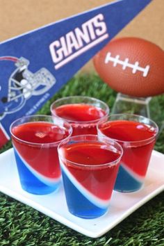 four cups filled with red, white and blue jello sitting on top of a plate