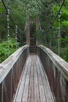 an old wooden bridge in the woods