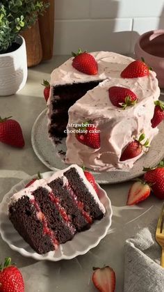 two slices of chocolate cake with strawberries on the side and one slice cut out