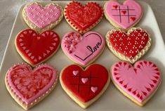 heart shaped cookies are arranged on a plate