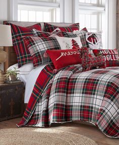 a red and white plaid comforter set with christmas decorations on the pillowcases