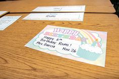 a wooden table topped with cards and envelopes