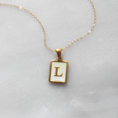 "Trendy and chic this necklace is made for everyday! Wear your favorite letter on a rectangle pendant, perfect for a gift too! D E T A I L S -Gold plated rectangle initial pendant -Mother of Pearl inlay -14kt Gold filled necklace in your choice of style LENGTH - Please select from the drop down selection. - Choose a 16, 18 or 20 inch inch necklace length. - Standard Length is 18 inches - Pictured at 18\" in photos. ∙ EXTRA LOVE ∙ Crafted and curated just for you in the desert of our Arizona stud Dainty Letter Necklaces For Everyday Wear, Dainty Letter Necklaces For Everyday, Dainty Letter Necklace For Everyday Wear, White Personalized Charm Necklace For Everyday, Personalized White Charm Necklace For Everyday, White Tarnish Resistant Necklace With Initial Pendant, Everyday White Personalized Charm Necklaces, Everyday Personalized White Charm Necklace, White Tarnish Resistant Initial Pendant Necklace