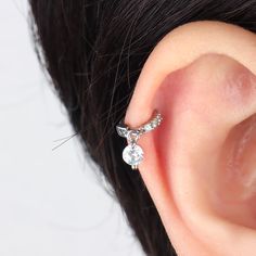 A true eye-catching dazzler, this sparkling round drop hoop is ideal to wear alone or matching with our studs, hoops for a cohesive look. With a flesh set of cubic zirconia sparkling gems, it is the touch of luxury you've been looking for to add to your everyday look! Detail： -Material: stainless steel -Used in healed piercings. -Tarnish proof and durable so you can wear it everyday without worry! Quantity & Measurement：-Gauge: 20g-Diameter: 5mm | 0.20"-Include: 1*Cozy-Comfortable to wear, hypoa Silver Ear Cuff With Diamond Accents, Silver Cubic Zirconia Ear Cuff With Diamond Accents, Cubic Zirconia Round Ear Cuff, Silver Cubic Zirconia Piercings With Sparkling Stones, Cubic Zirconia Dangle Ear Cuff, Silver Huggie Piercings In Cubic Zirconia, Diamond Accented Piercings For Anniversary, Cubic Zirconia Cartilage Earrings For Wedding, Elegant Small Hoop Cubic Zirconia Piercing