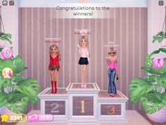 three barbie dolls standing on top of a podium