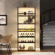 the shelves are filled with wine bottles and other items in front of a staircase case