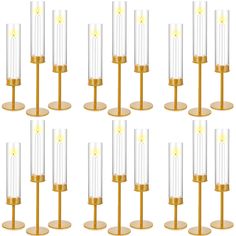 twelve candles with gold bases and clear glass tubes on each candle holder, set of eight