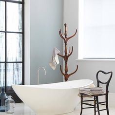 a white bath tub sitting next to a window