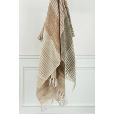 a tan and white towel hanging on a hook