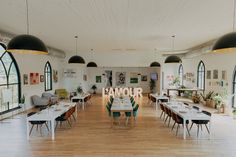 an empty restaurant with tables and chairs in the center, surrounded by large arched windows